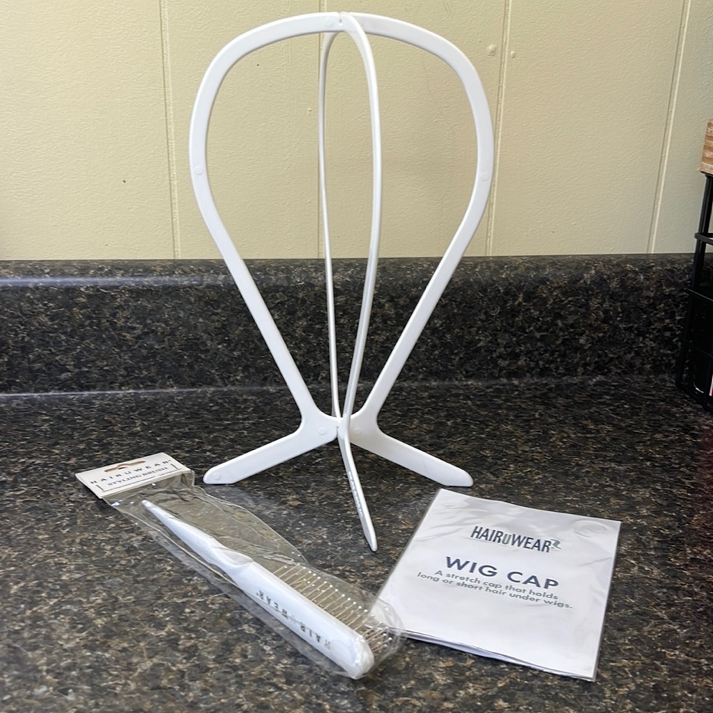 Wig stand , brush, and wig cap.